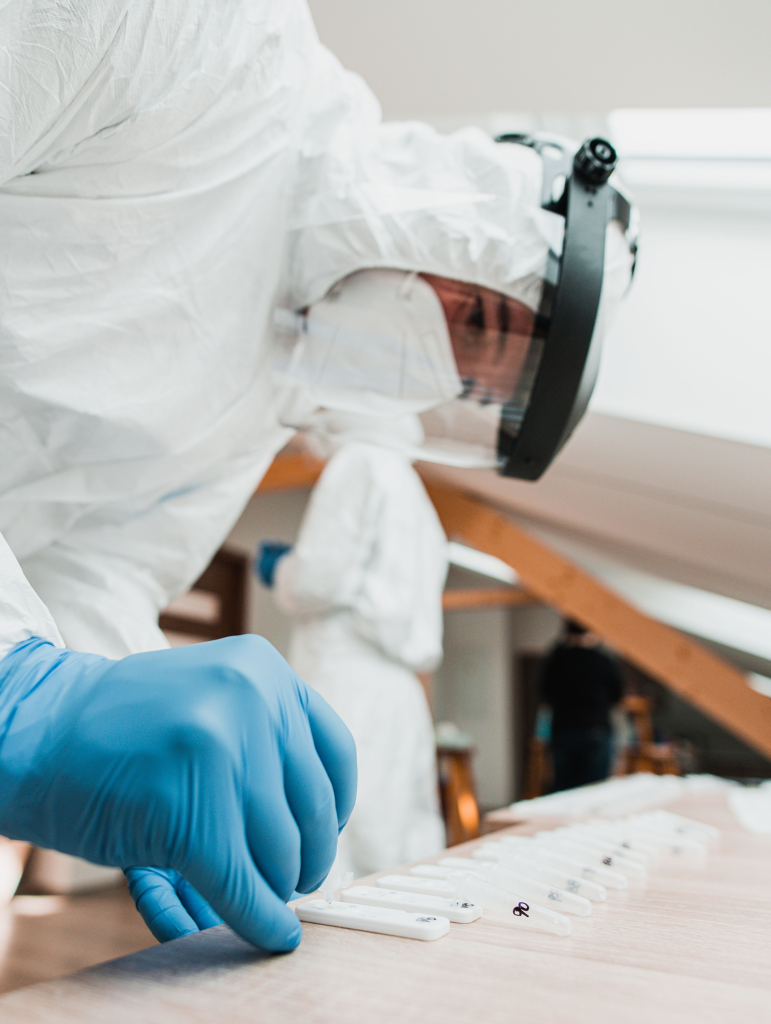 Technician conducting mold testing in protective gear